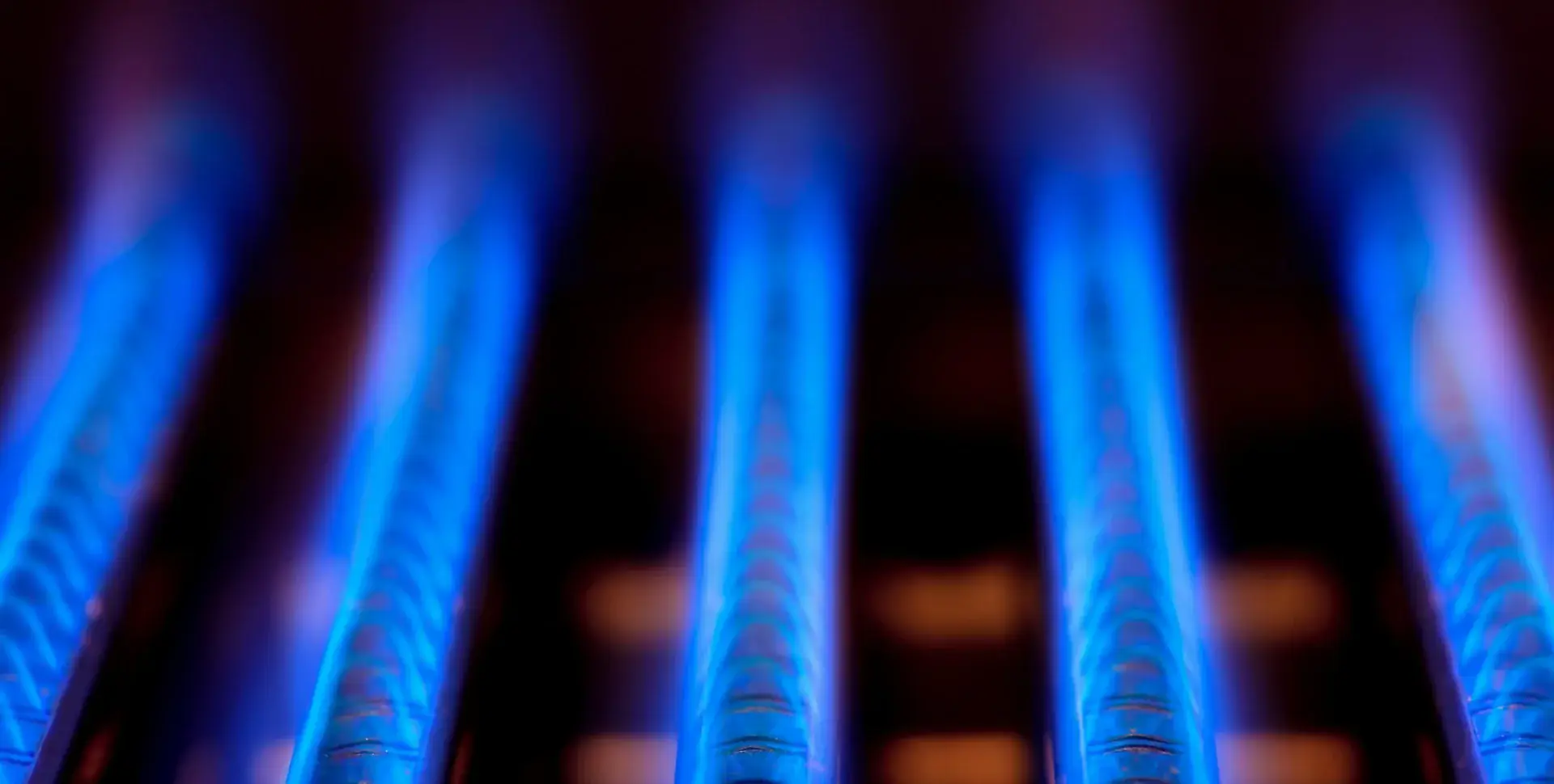 Blue flames along the burner tubes of a gas water heater