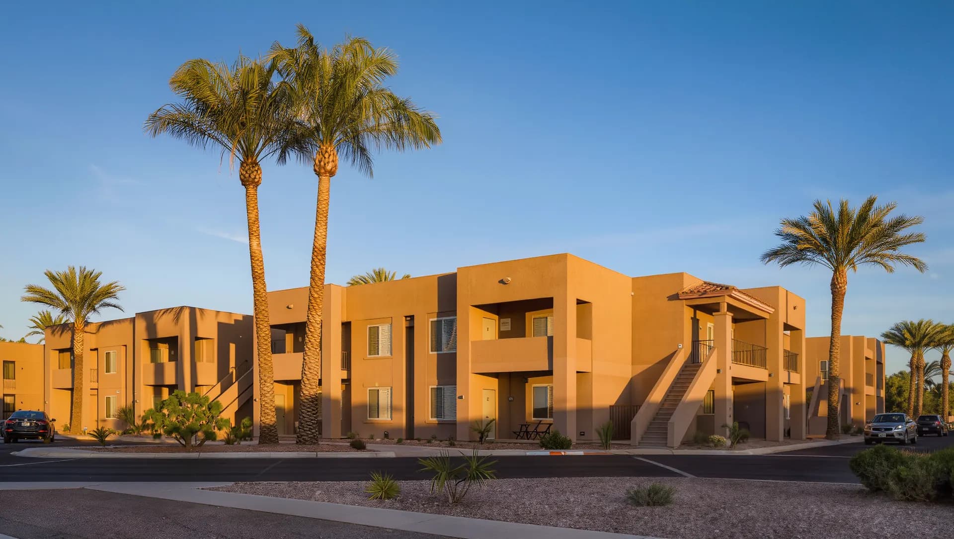 Two-story stucco apartment complex in Phoenix at golden hour